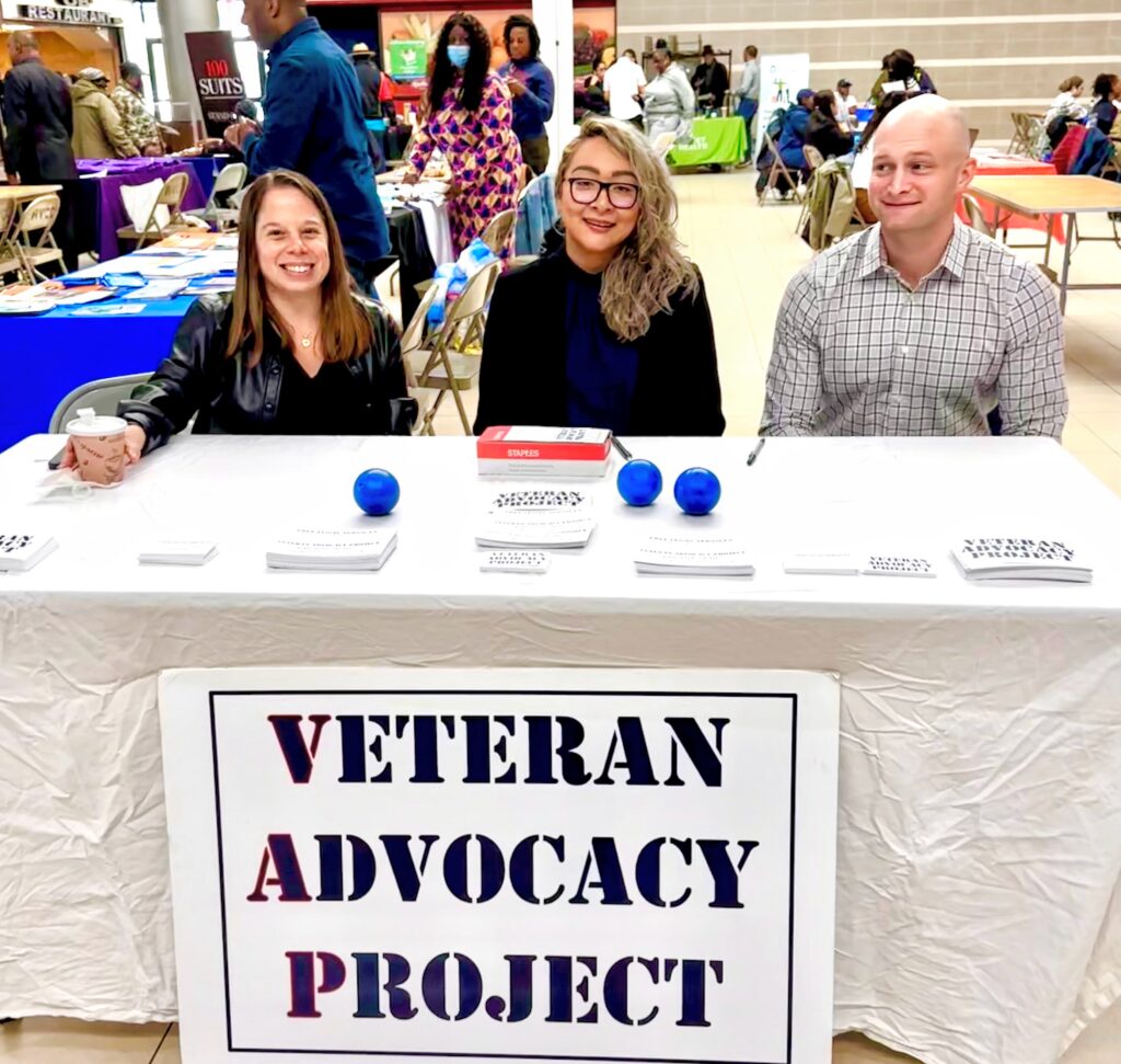 Amy Hozer-Weber, Connie Cabrera, and Sean Milde tabling at an outreach event with veterans and families in Queens, NY.